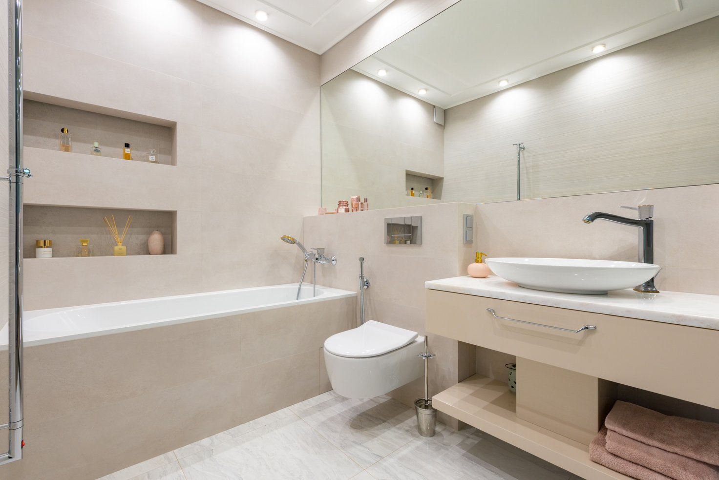 Bathroom interior with sink on counter near toilet and bath