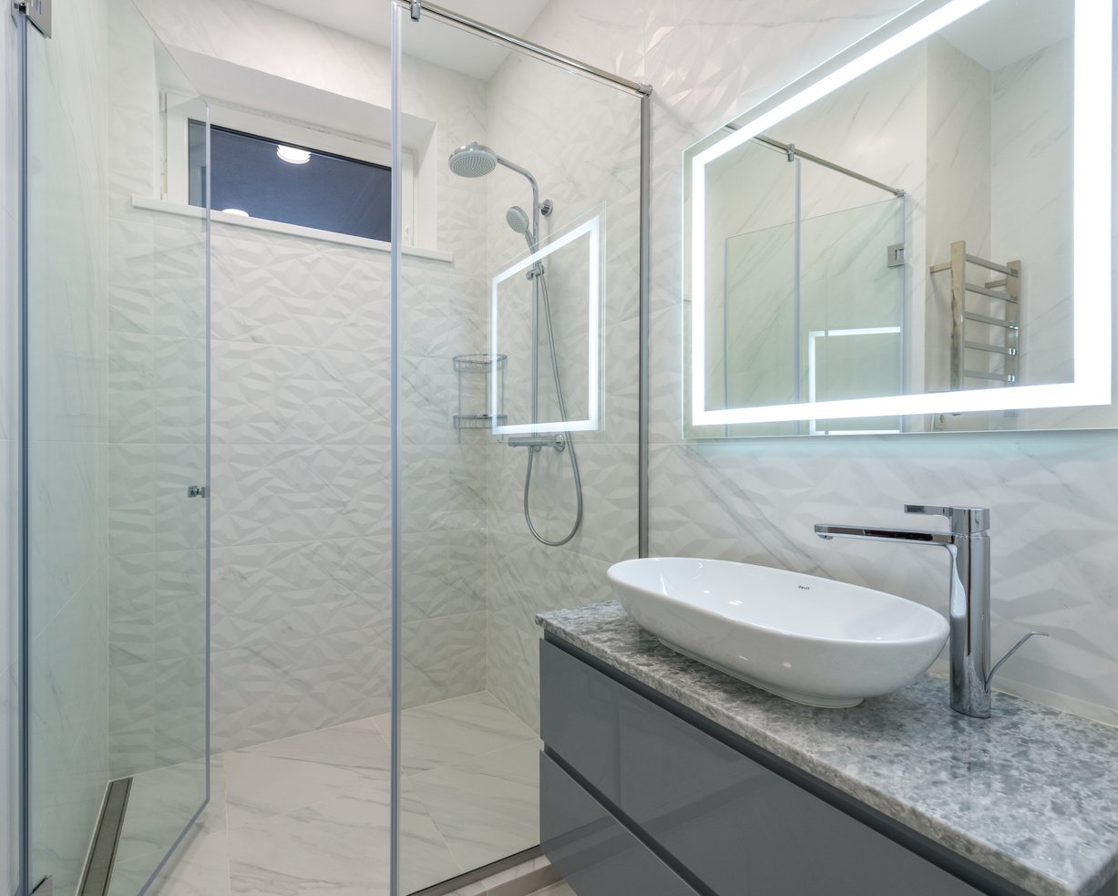 Interior of modern bathroom with shower cabin and sink