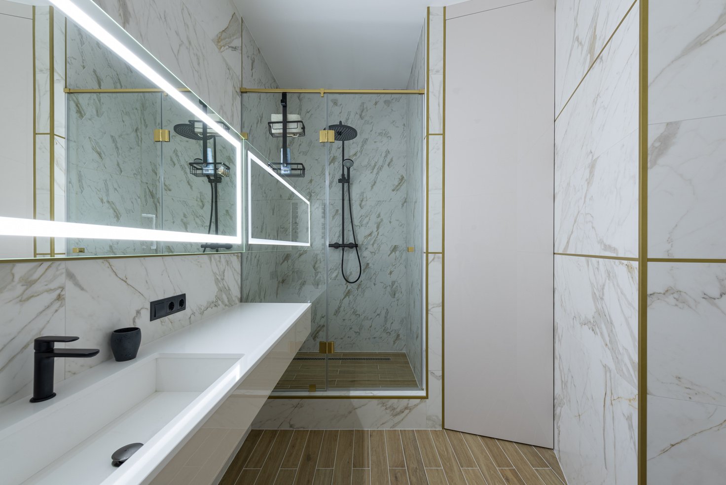 Minimalist styled bathroom with tiled walls and shower cabin